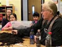 Sue Isbell, NDSU Extension - Sioux County agent, visits with youth during a science day camp. (NDSU Photo)