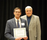Greg Endres, left, receives the AGSCO Excellence in Extension Award from David Buchanan, associate dean for academic programs. (NDSU photo)