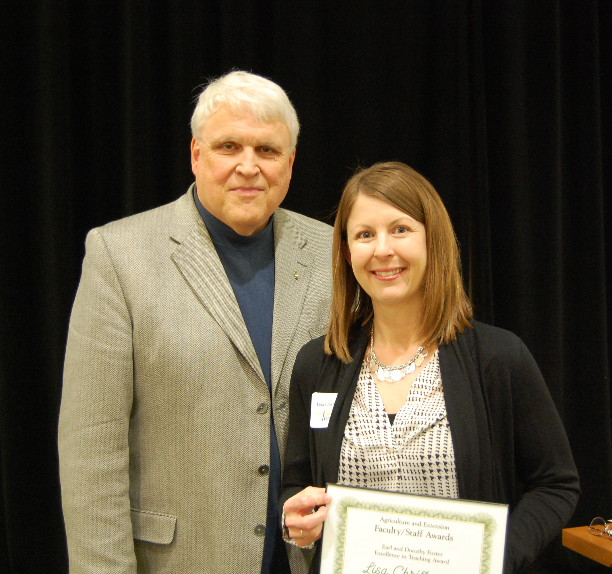 Lisa Christenson, right, receives the Earl and Dorothy Foster Excellence in Teaching Award from David Buchanan, associate dean for academic programs. (NDSU photo)