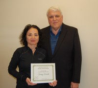 Senay Simsek, left, receives the Eugene R. Dahl Excellence in Research Award from David Buchanan, associate dean for academic programs. (NDSU photo)