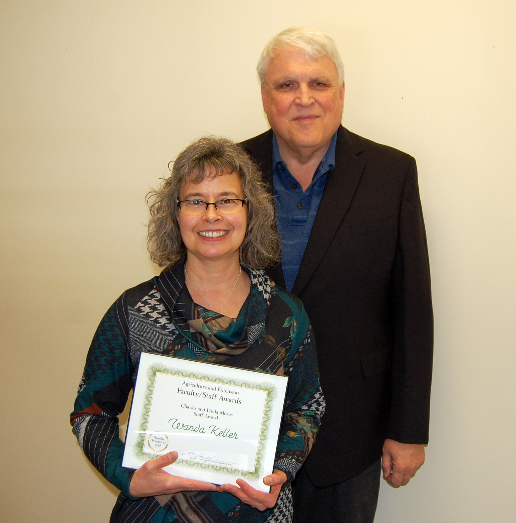 Wanda Keller, left, receives the Charles and Linda Moses Staff Award from David Buchanan, associate dean for academic programs. (NDSU photo)