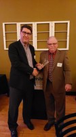 Michael O’Keeffe, left, accepts Rural Leadership North Dakota's Leader Award from Barry Medd, RLND Council chair. (NDSU photo)