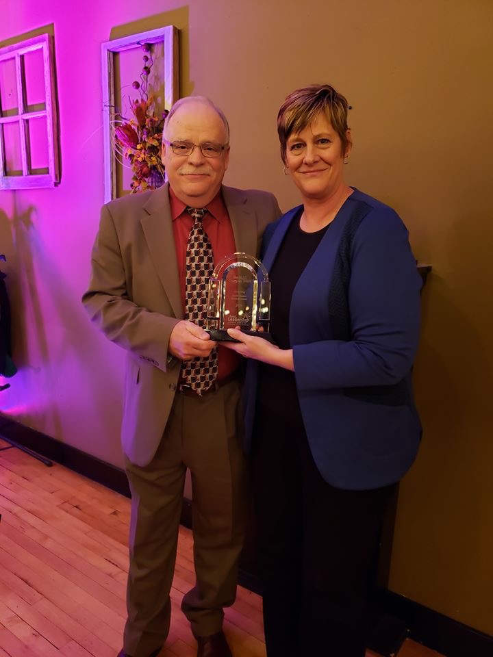 Pam Musland, communications director for the North Dakota Farmers Union, accepts Rural Leadership North Dakota's Champion Award from Barry Medd, RLND Council chair. (NDSU photo)