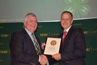 Brad Cogdill, Center for 4-H Youth Development chair, is honored for his 40 years of service to NDSU Extension.