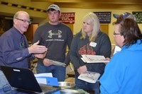 Dean Aakre, NDSU Extension 4-H youth development specialist (left) talks to volunteers during a project training session. (NDSU photo)