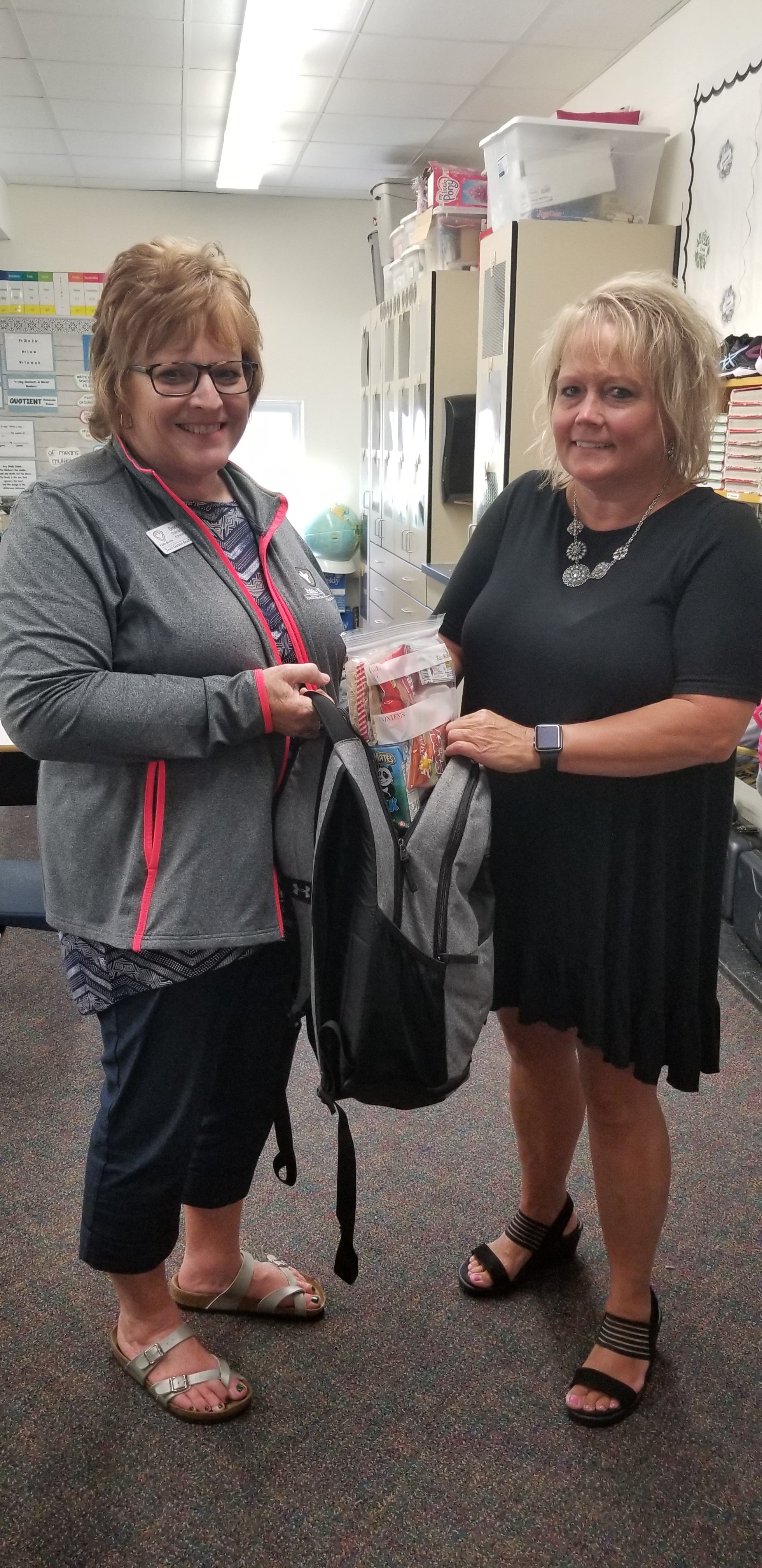 Volunteers fill a backpack with food for an RLND project to meet the weekend nutritional needs of students struggling with hunger. (Photo courtesy of Brenda Stallman, Hillsboro, N.D.)