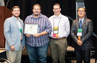 Chris Augustin, second from left, received second place nationally in the poster category, applied research division, during the National Association of County Agricultural Agents conference. (NDSU photo)
