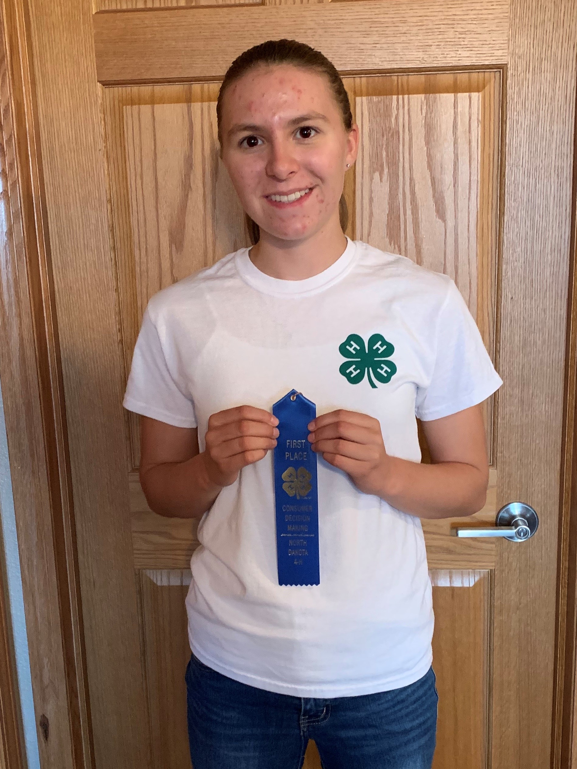 Faith Norby shows off her award from the 2020 North Dakota 4-H consumer decision making contest. She is a member of the Stark-Billings County team who took first place in the senior division. (NDSU photo)