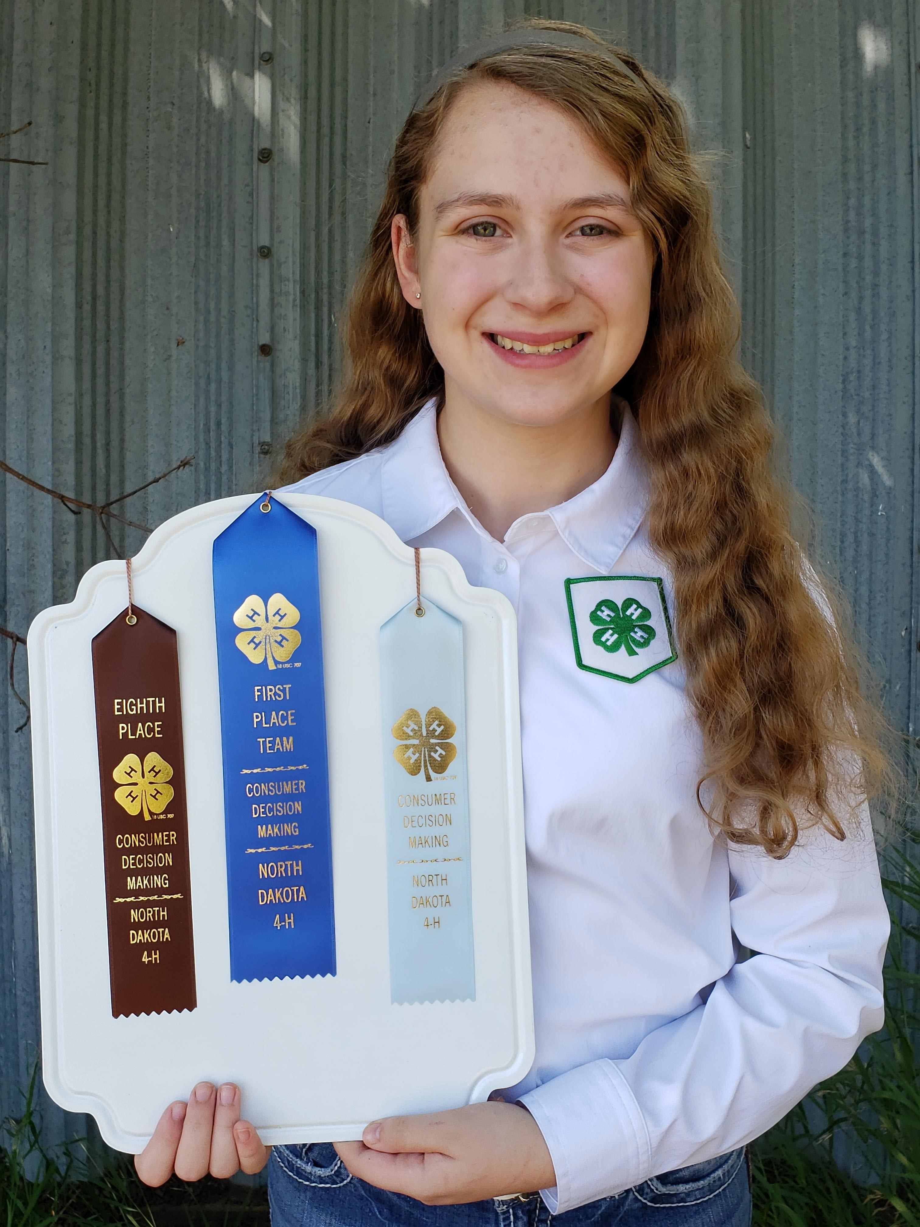 Michaela Mitchell displays the awards she received as part of the Stark-Billings County team who took first place in the 2020 North Dakota 4-H consumer decision making contest. (NDSU photo)