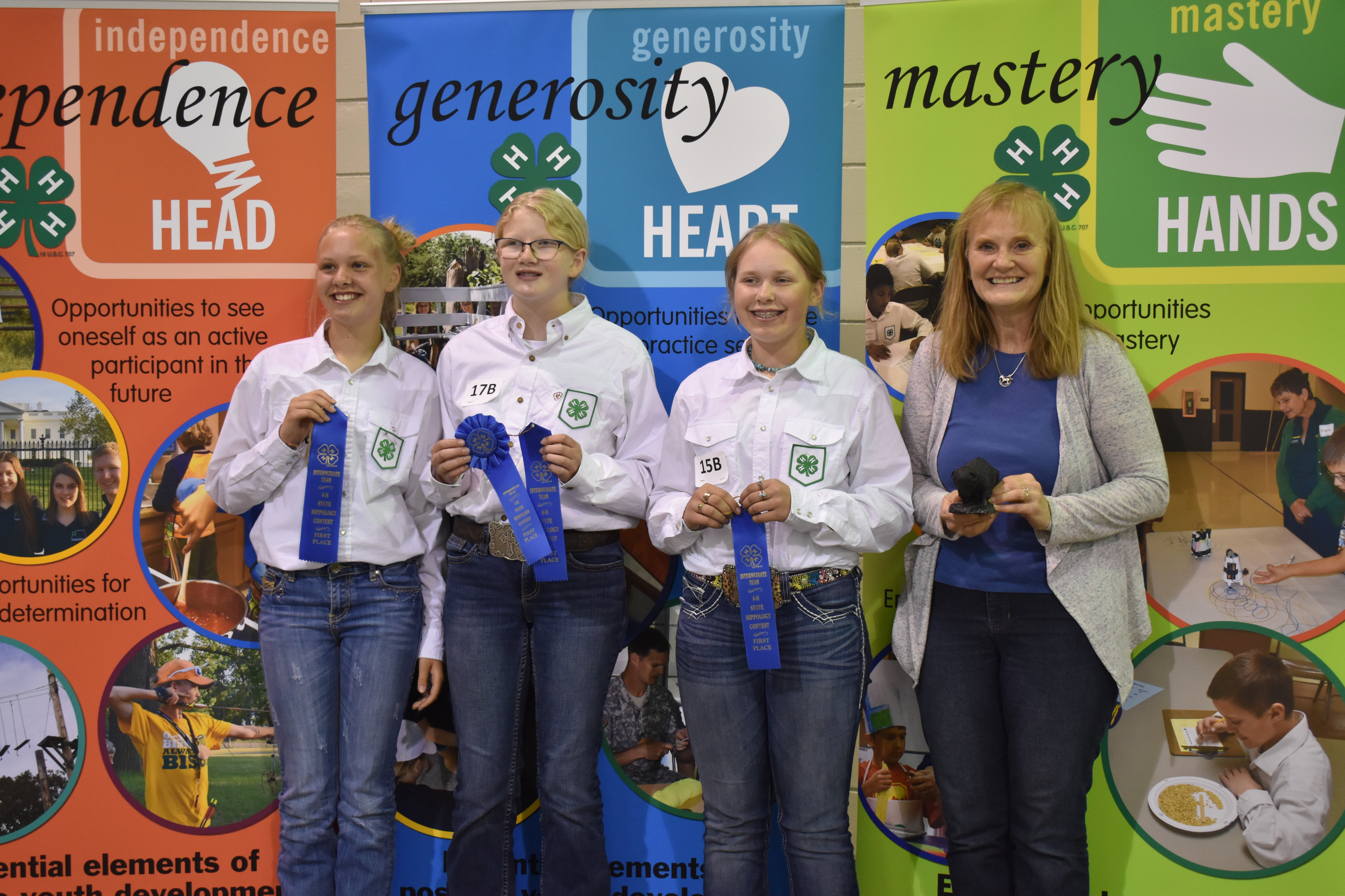 The Pierce County team takes first place in the intermediate division of the hippology contest. Pictured are, from left: team members Jesse Wolf, Maggie Iverson and Kami Guty, and coach Diane Randle. (NDSU photo)