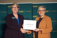 NDSU Extension and REC faculty and staff were honored for their years of service at the joint fall conference held in Bismarck, N.D., last week. Pictured left to right: Lynette Flage, NDSU Extension associate director, honors Andrea Bowman, NDSU Extension program coordinator for leadership and civic engagement, for her 15 years of service. (NDSU Photo)