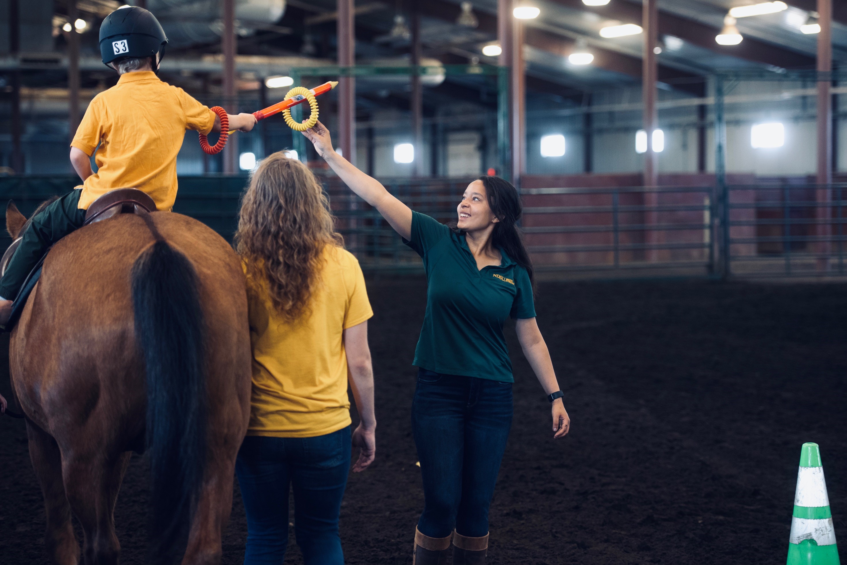 A Bison Strides participant builds hand-eye coordination during a stretching and strengthening exercise. (NDSU photo)