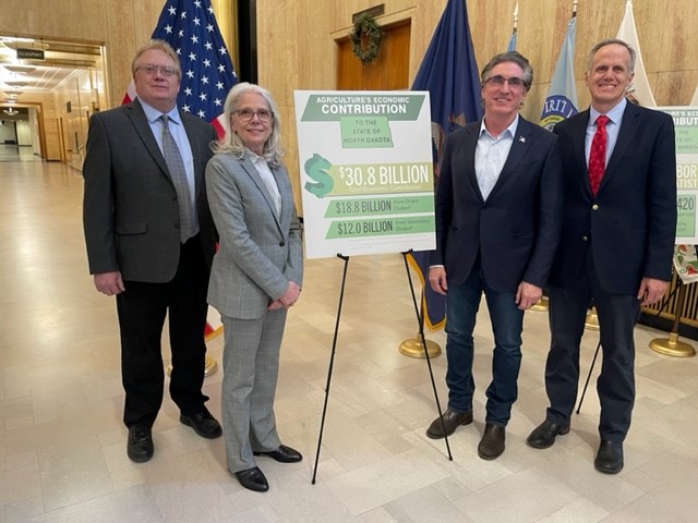 NDSU researchers Dean Bangsund and Nancy Hodur, Governor Doug Burgum, and Greg Lardy, vice president for Agricultural Affairs at NDSU share the economic contributions of agriculture during a press release at the state capitol. (Photo courtesy of Nancy Johnson)