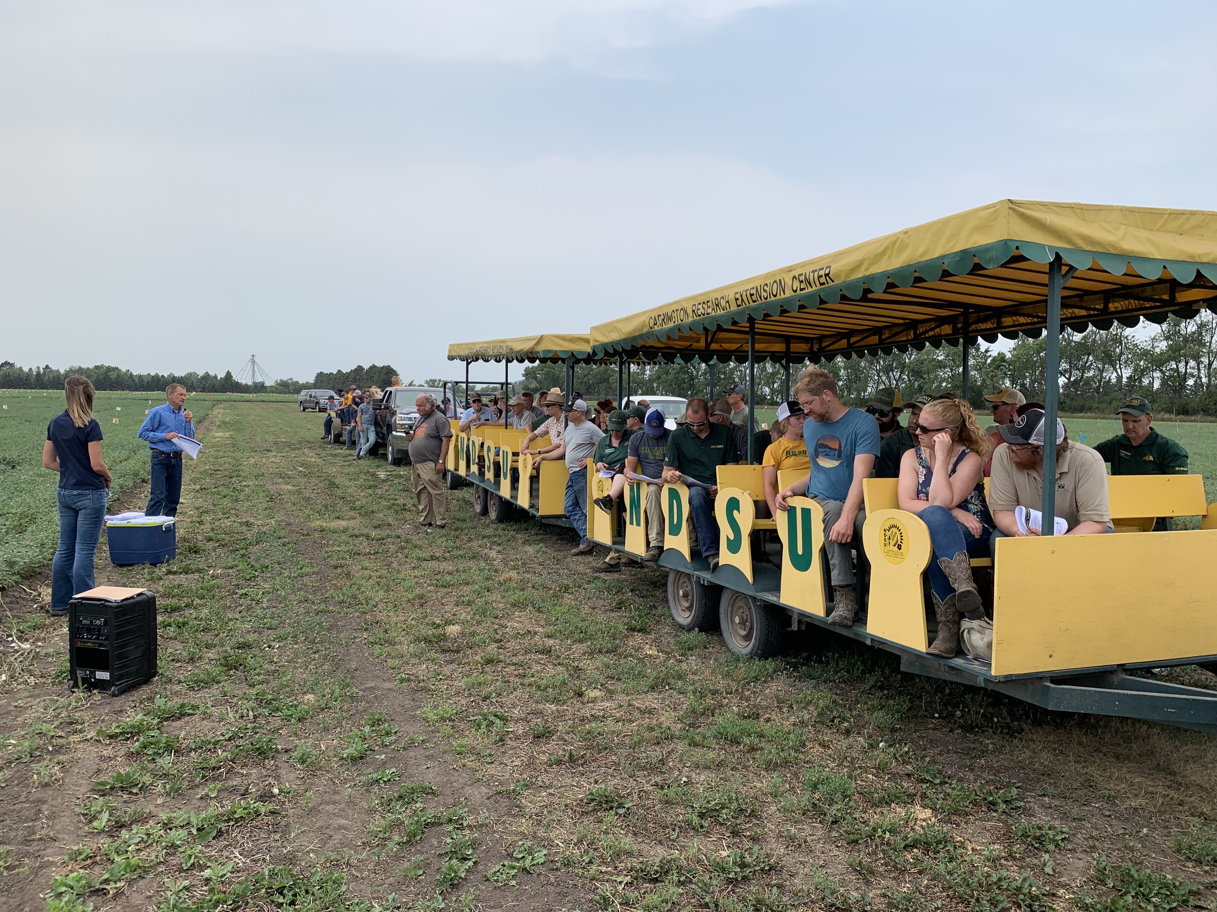 NDSU plant pathology research specialist Suanne Kallis and plant pathologist Michael Wunsch speak to visitors about plant pathology projects at the CREC’s 2021 field day. (NDSU photo)