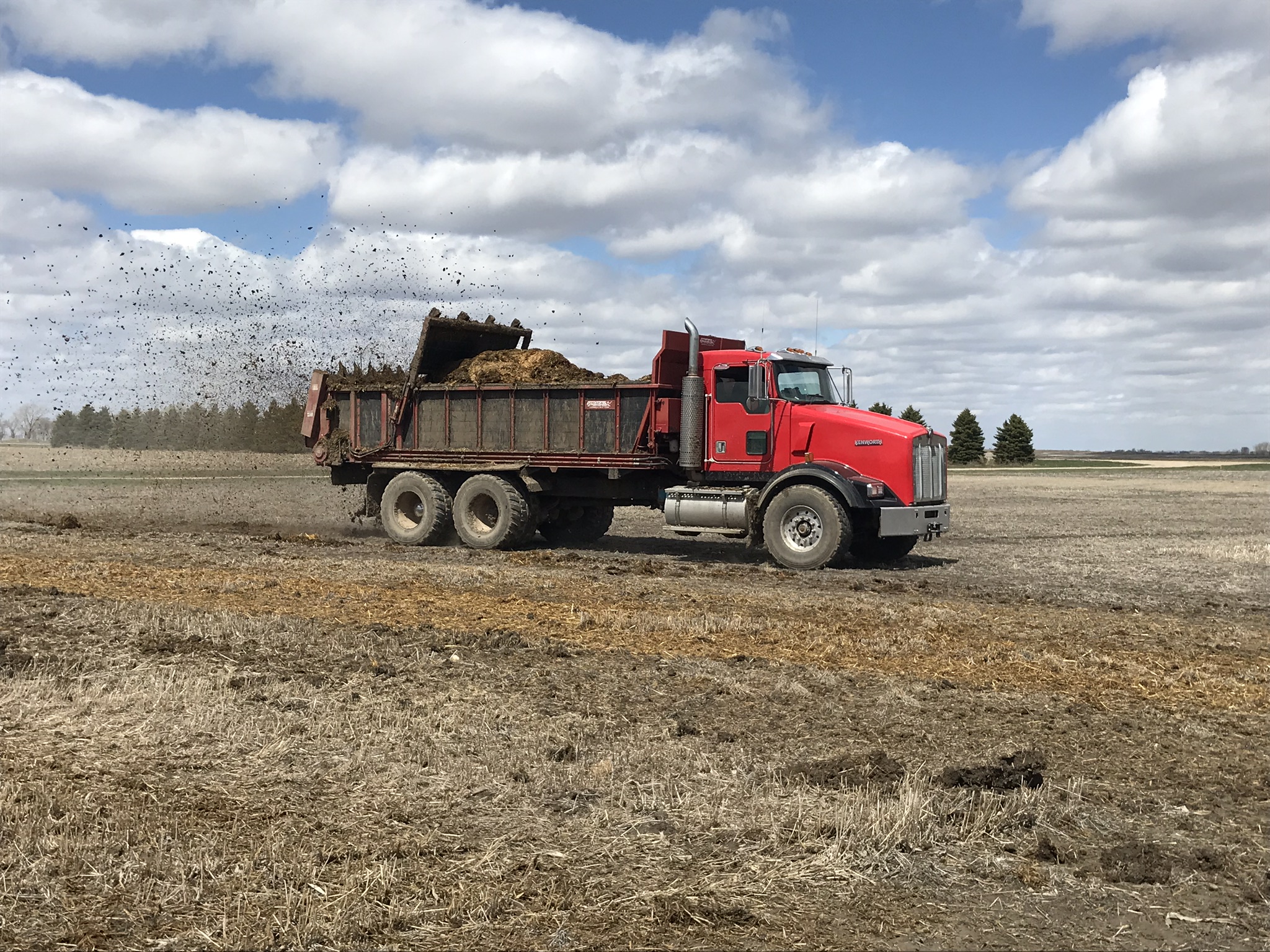 A truck-mounted horizontal spreader applies manure to a field at the NDSU Carrington Research Extension Center. (NDSU photo)