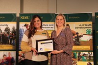 Emily Bultema (R), Alzheimer's Association of Minnesota and North Dakota, accepts the Friend of North Dakota Extension Association of Family and Consumer Sciences award from the association president Erin Berentson (L).