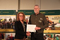 NDSU Extension specialist Andrew Thostenson (R) received the Continued Excellence Award. Pictured with Jodi Bruns (L), NDSU leadership and civic engagement specialist and president of Upsilon chapter of Epsilon Sigma Phi.