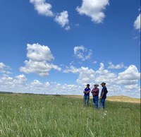 Karl Hoppe, NDSU Extension livestock systems specialist, (center) visits with past grant recipients Erin Gaugler (left) and Drew Gaugler (right) about their project. (NDSU photo)