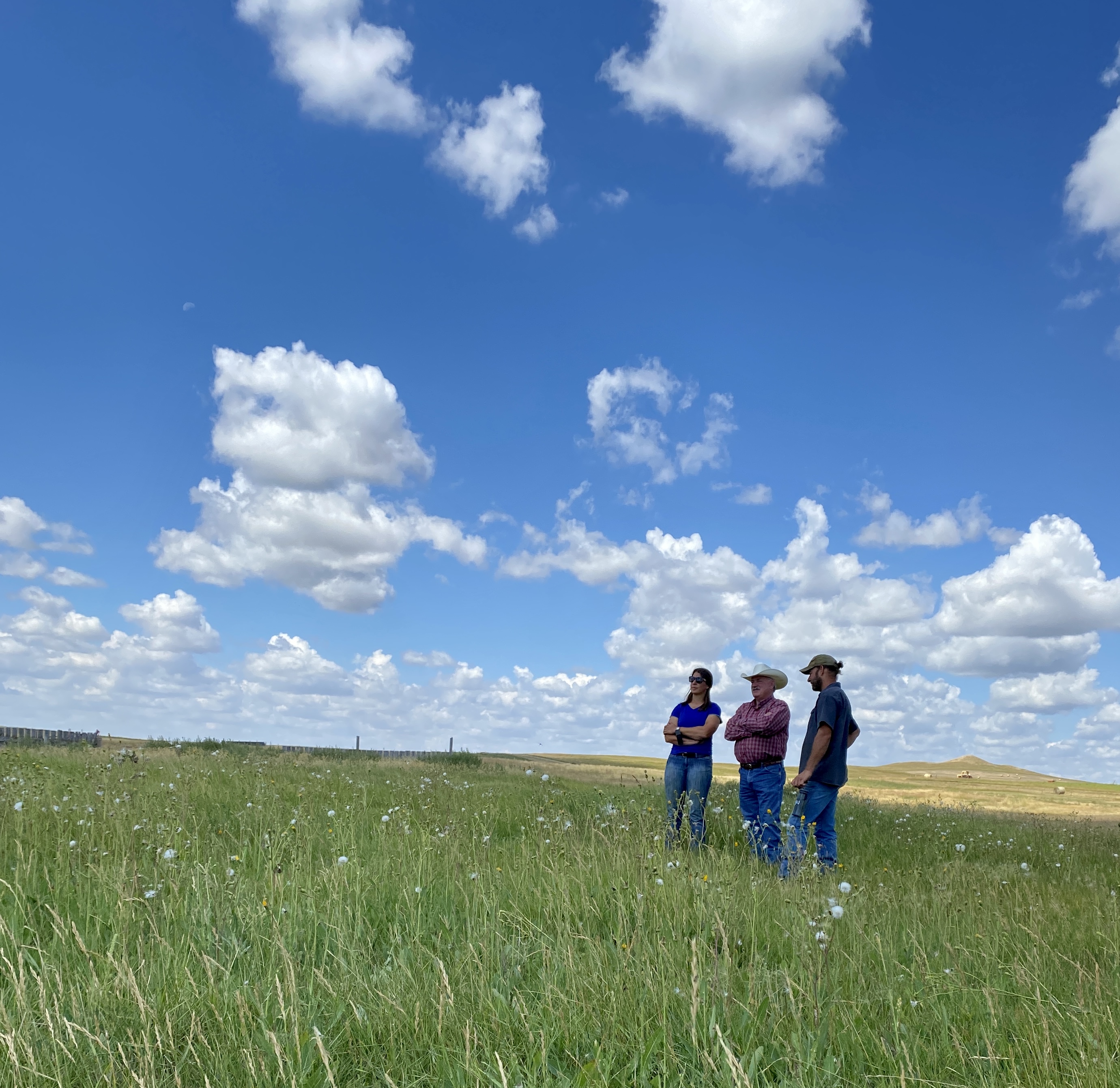 Karl Hoppe, NDSU Extension livestock systems specialist, (center) visits with past grant recipients Erin Gaugler (left) and Drew Gaugler (right) about their project. (NDSU photo)