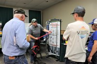 Angie Johnson, NDSU Extension farm and ranch safety coordinator, demonstrates grain bin safety equipment during the last year's Big Iron farm show. (NDSU photo)