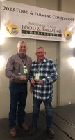 NDSU Carrington Research Extension Center’s Karl Hoppe and Steve Zwinger (retired) receive awards at the Northern Plains Food and Farming Conference. (NDSU photo)