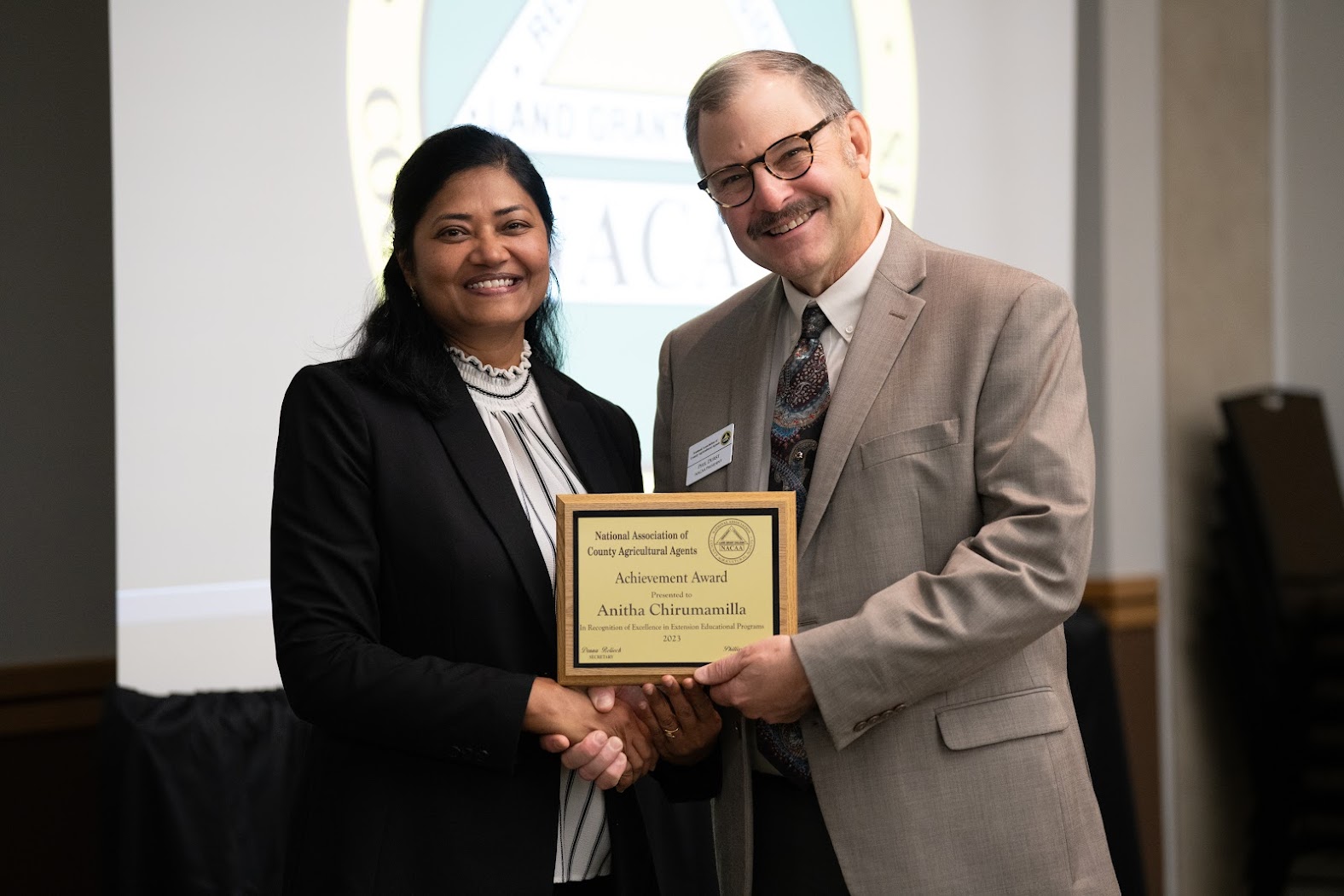 Anitha Chirumamilla, Extension cropping systems specialist at the NDSU Langdon Research Extension Center, receives the National Achievement Award at the National Association of County Agricultural Agents conference. (NDSU photo)