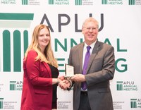 Shana Forster, NDSU, receives a recognition award from Food Systems Leadership Institute director Sam Pardue for her achievements as a fellow in the institute.