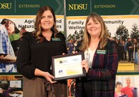 Erin Berentson (left) presents the Friend of North Dakota Extension Association of Family and Consumer Sciences award to Julie Garden-Robinson, who is receiving the award on behalf of the North Dakota Nutrition Council. (NDSU photo)