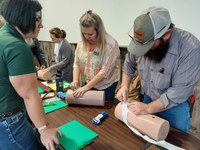 Participants at a recent Stop the Bleed training practice properly using a tourniquet in the event of blood loss caused by an injury. (NDSU photo)