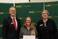 Cassie Dick (center) is recognized for 15 years of service to NDSU Extension and the Hettinger Research Extension Center. Also pictured are Greg Lardy, vice president for NDSU Agriculture, and Lynette Flage, associate director for NDSU Extension. (NDSU photo)