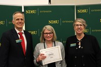 Cindy Cross (center) is recognized for 15 years of service to NDSU Extension and the North Central Research Extension Center. Also pictured are Greg Lardy, vice president for NDSU Agriculture, and Lynette Flage, associate director for NDSU Extension. (NDSU photo)