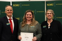Nicole Kaylor (center) is recognized for five years of service to NDSU Extension. Also pictured are Greg Lardy, vice president for NDSU Agriculture, and Lynette Flage, associate director for NDSU Extension. (NDSU photo)