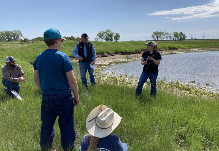 An NDSU Extension agent demonstrates how to use a TDS meter to screen a livestock water source. (NDSU photo)