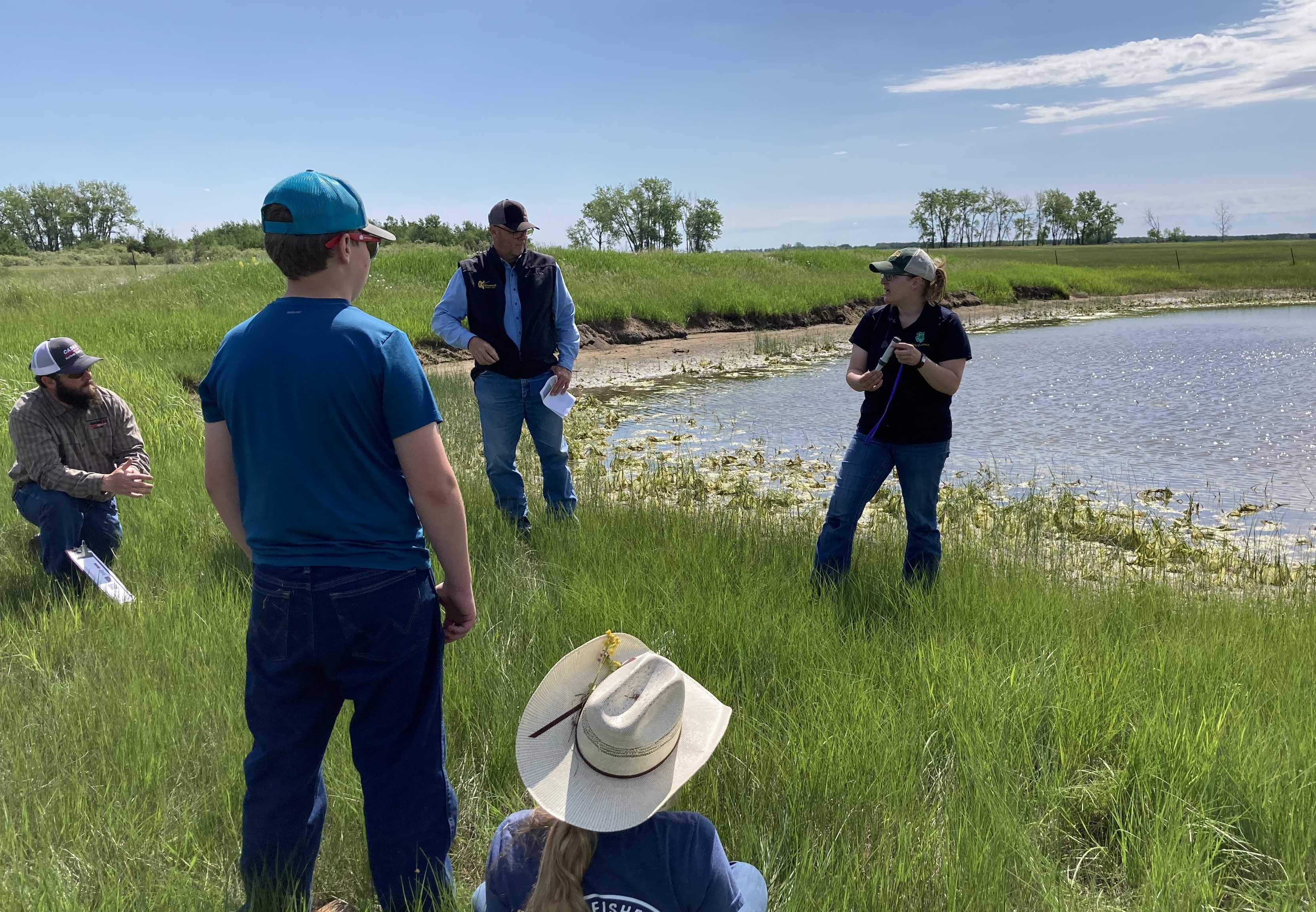 An NDSU Extension agent demonstrates how to use a TDS meter to screen a livestock water source. (NDSU photo)