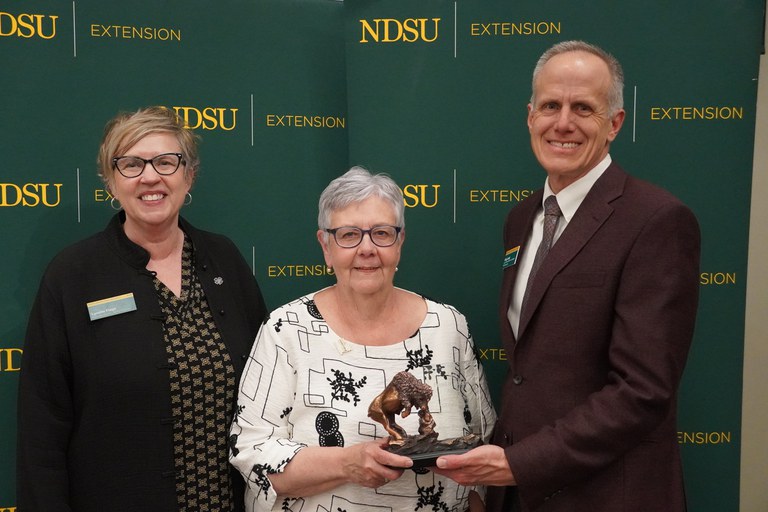 JoAnn Rodenbiker (center), is honored with the 2024 Friend of Extension award by Lynette Flage (left), NDSU Extension associate director, and Greg Lardy (right), Joe and Norma Peltier Vice President for Agriculture at NDSU. (NDSU photo)