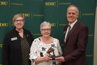 JoAnn Rodenbiker (center), is honored with the 2024 Friend of Extension award by Lynette Flage (left), NDSU Extension associate director, and Greg Lardy (right), Joe and Norma Peltier Vice President for Agriculture at NDSU. (NDSU photo)