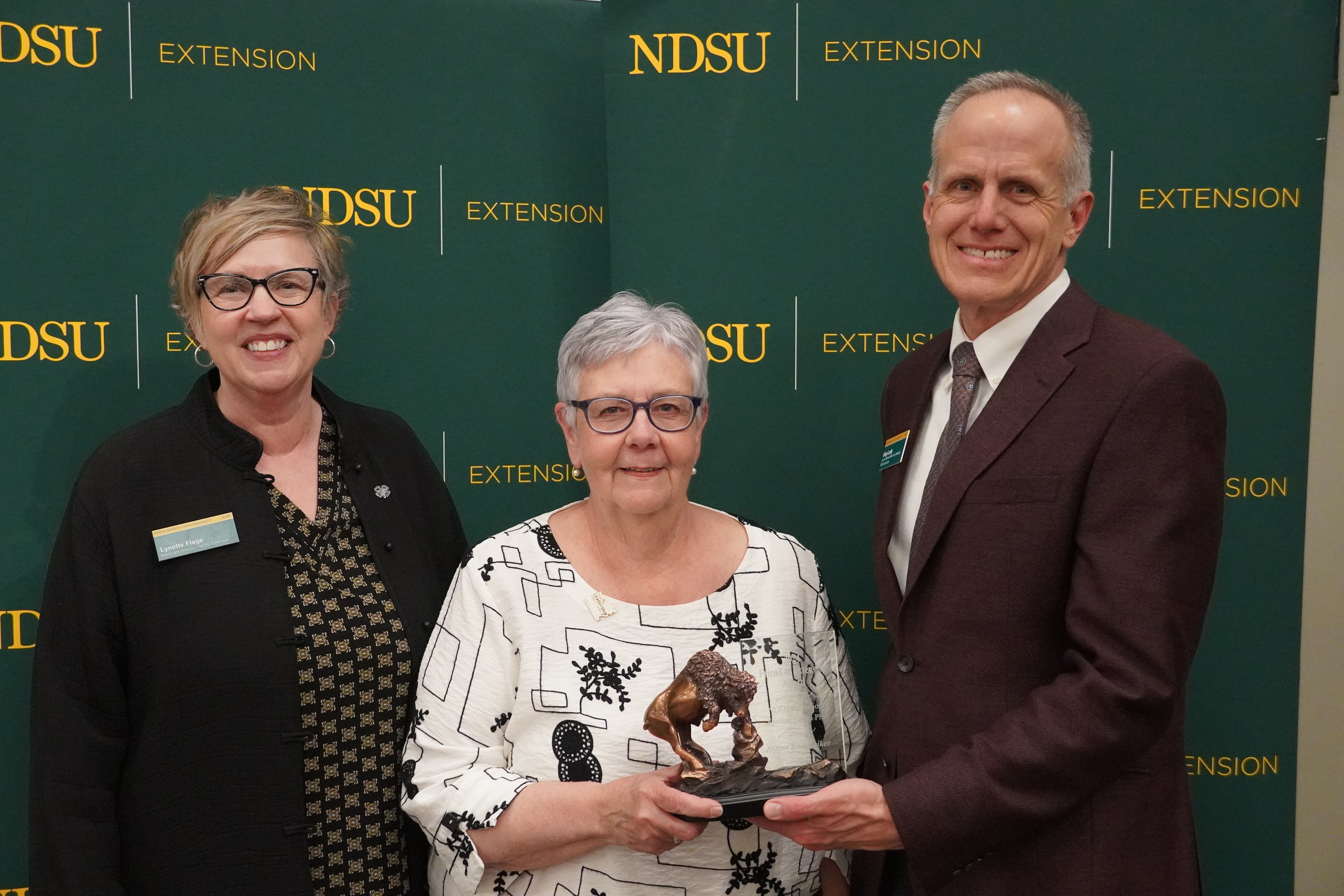 JoAnn Rodenbiker (center), is honored with the 2024 Friend of Extension award by Lynette Flage (left), NDSU Extension associate director, and Greg Lardy (right), Joe and Norma Peltier Vice President for Agriculture at NDSU. (NDSU photo)