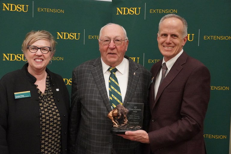 Larry Hoffmann (center), Cass County farmer, is honored with the 2025 Friend of Extension award by Lynette Flage (left), NDSU Extension associate director, and Greg Lardy (right), Joe and Norma Peltier Vice President for Agriculture at NDSU. (NDSU photo)