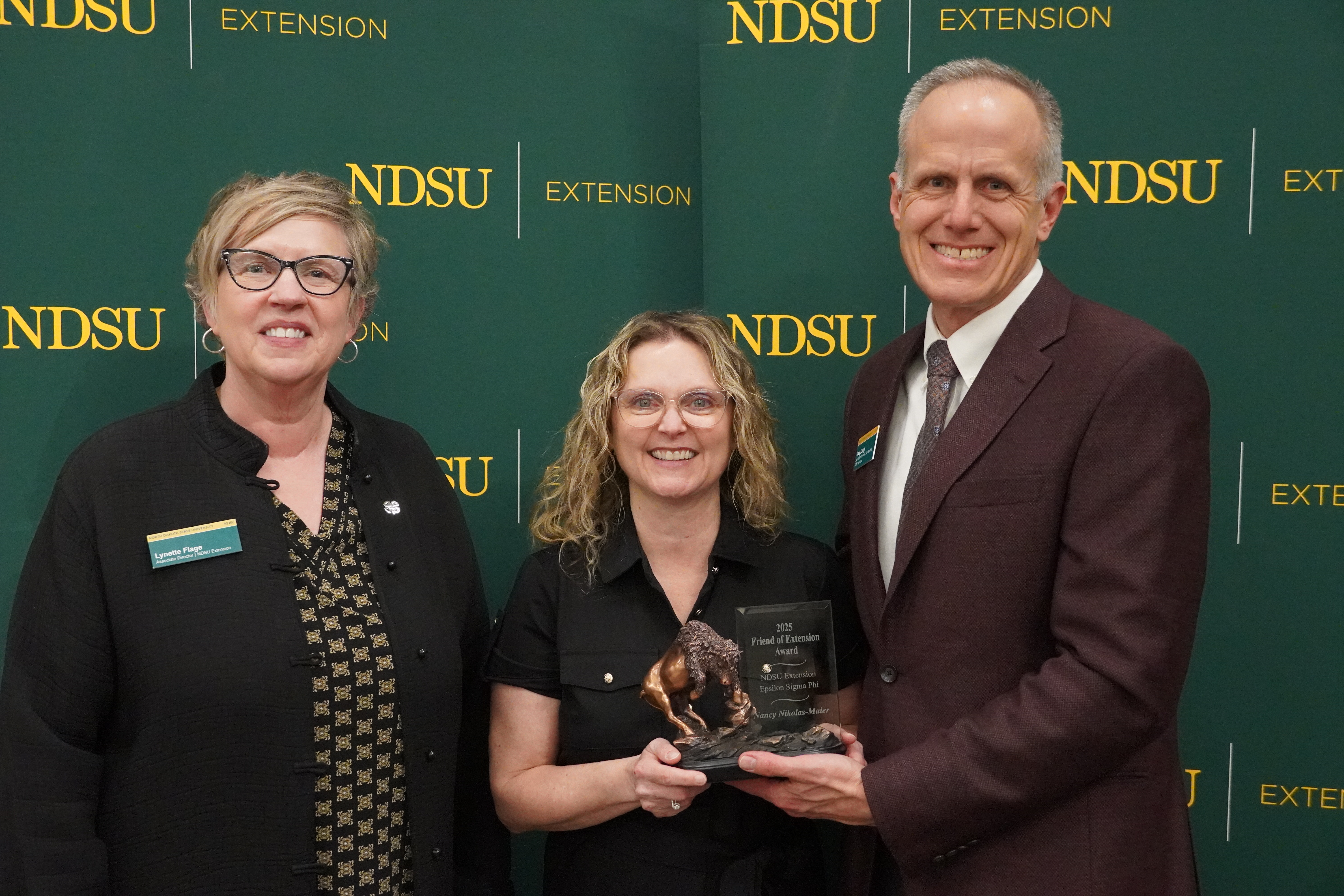 Nancy Nikolas-Maier (center), director of Adult and Aging Services at the North Dakota Department of Health & Human Services, is honored with the 2025 Friend of Extension award by Lynette Flage (left), NDSU Extension associate director, and Greg Lardy (right), Joe and Norma Peltier Vice President for Agriculture at NDSU. (NDSU photo)
