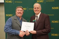 Kevin Sedivec (left), NDSU Extension rangeland management specialist at NDSU's Central Grasslands Research Extension Center, is honored for 35 years of service by Greg Lardy (right), Joe and Norma Peltier Vice President for Agriculture at NDSU. (NDSU photo)