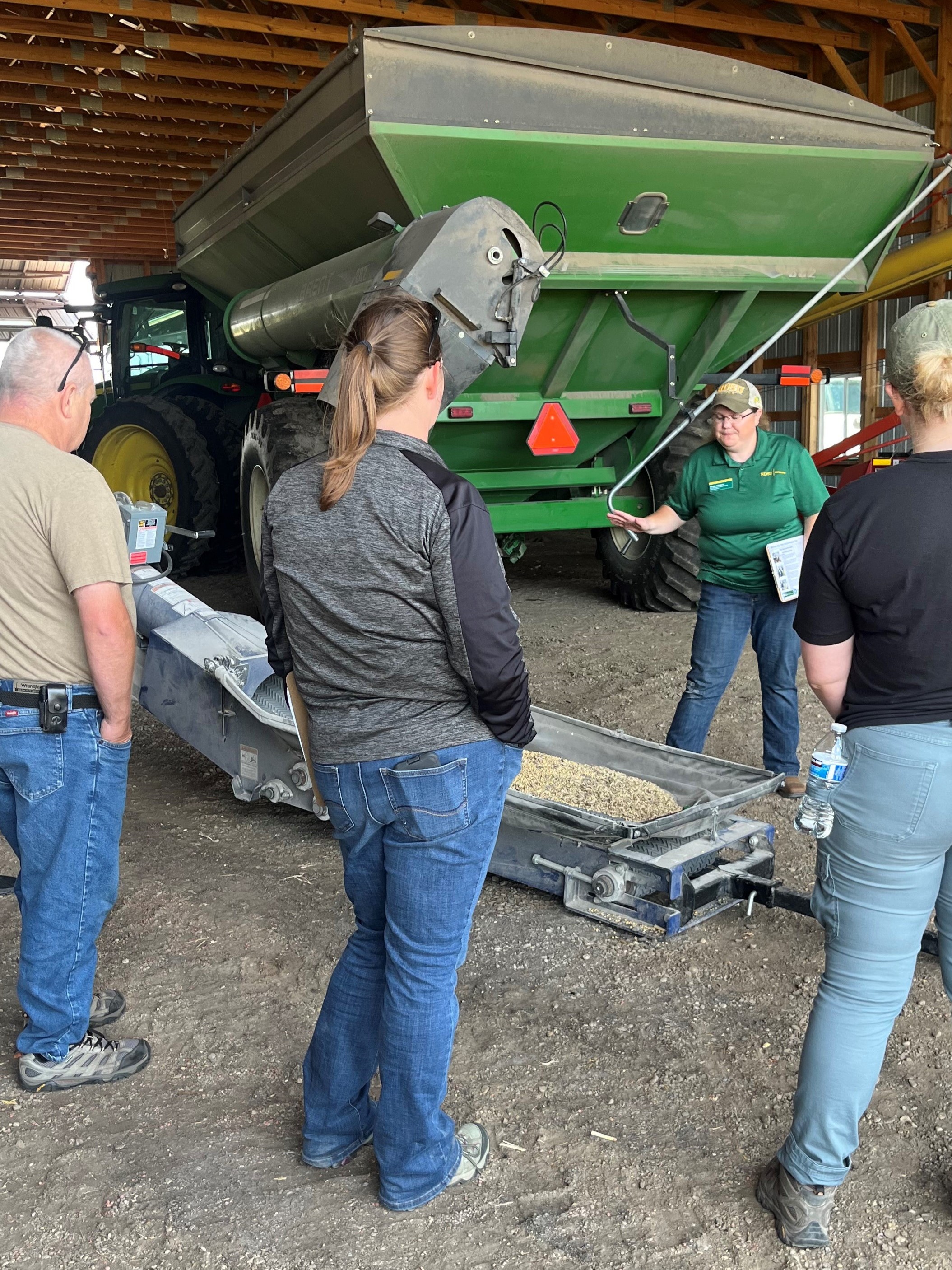Angie Johnson, NDSU Extension farm and ranch safety specialist, explains safety procedures around an auger. (NDSU photo)