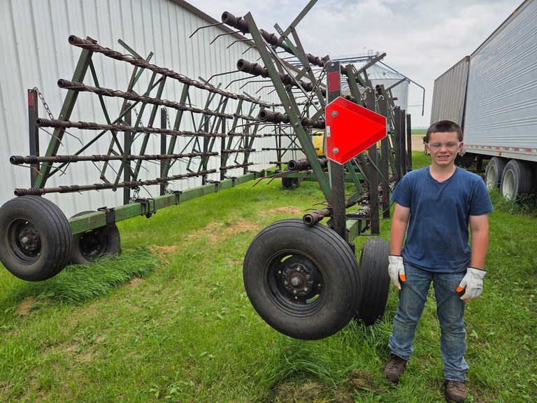 Ryan Steger of Richland County, North Dakota, placed third for properly installing a slow-moving vehicle sign on an applicator-equipped harrow. (NDSU photo)