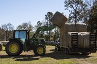 Loads such as seed, fertilizer, equipment and hay bales are subject to vibration, swaying, centrifugal force, inertia, wind and other forces during transit. (USDA photo)