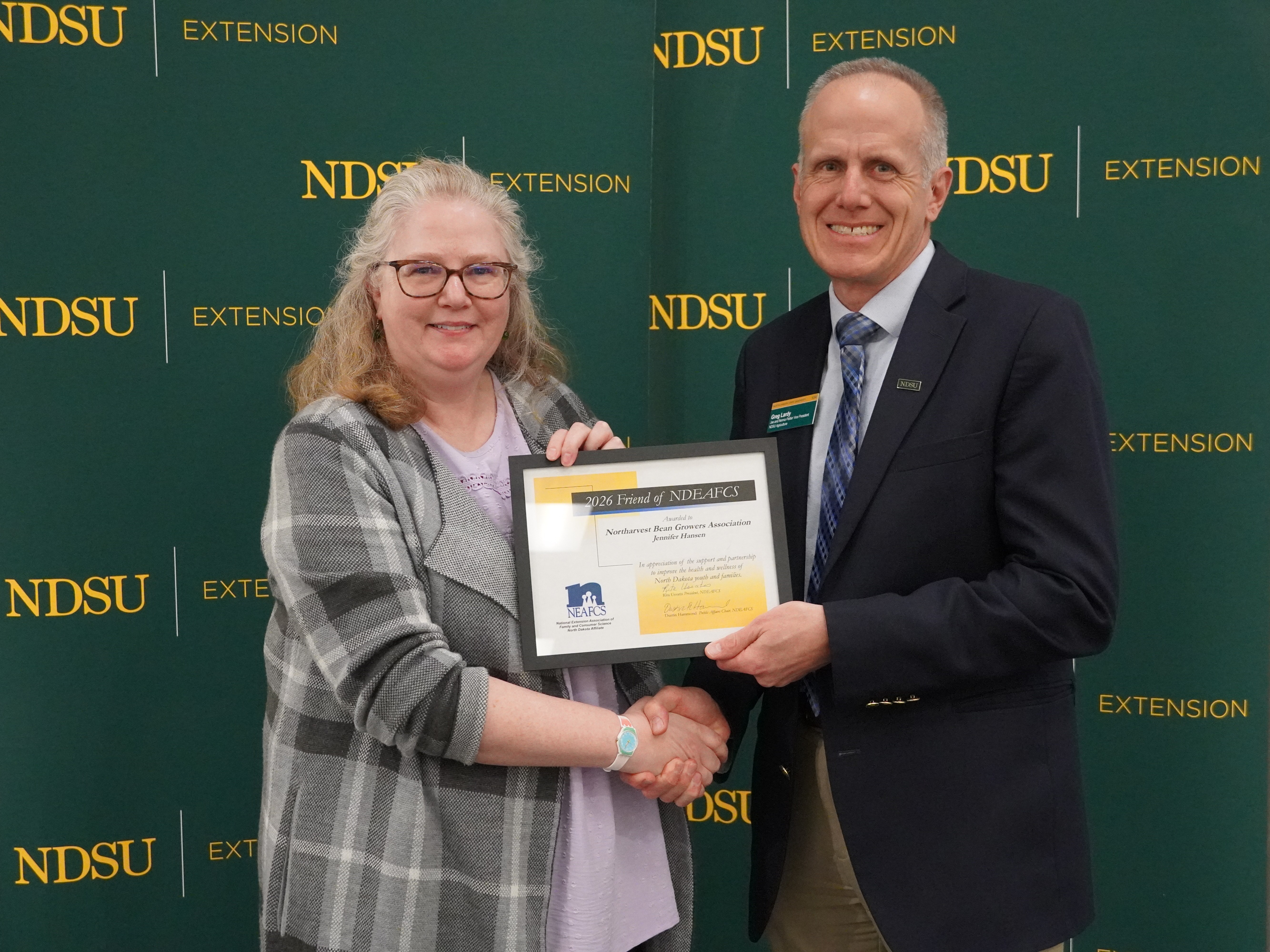Jennifer Hansen (left), finance director of the Northarvest Bean Growers Association, accepts the Friend of the North Dakota Extension Association of Family and Consumer Sciences award from Greg Lardy (right), Joe and Norma Peltier Vice President for Agriculture at NDSU. (NDSU photo)