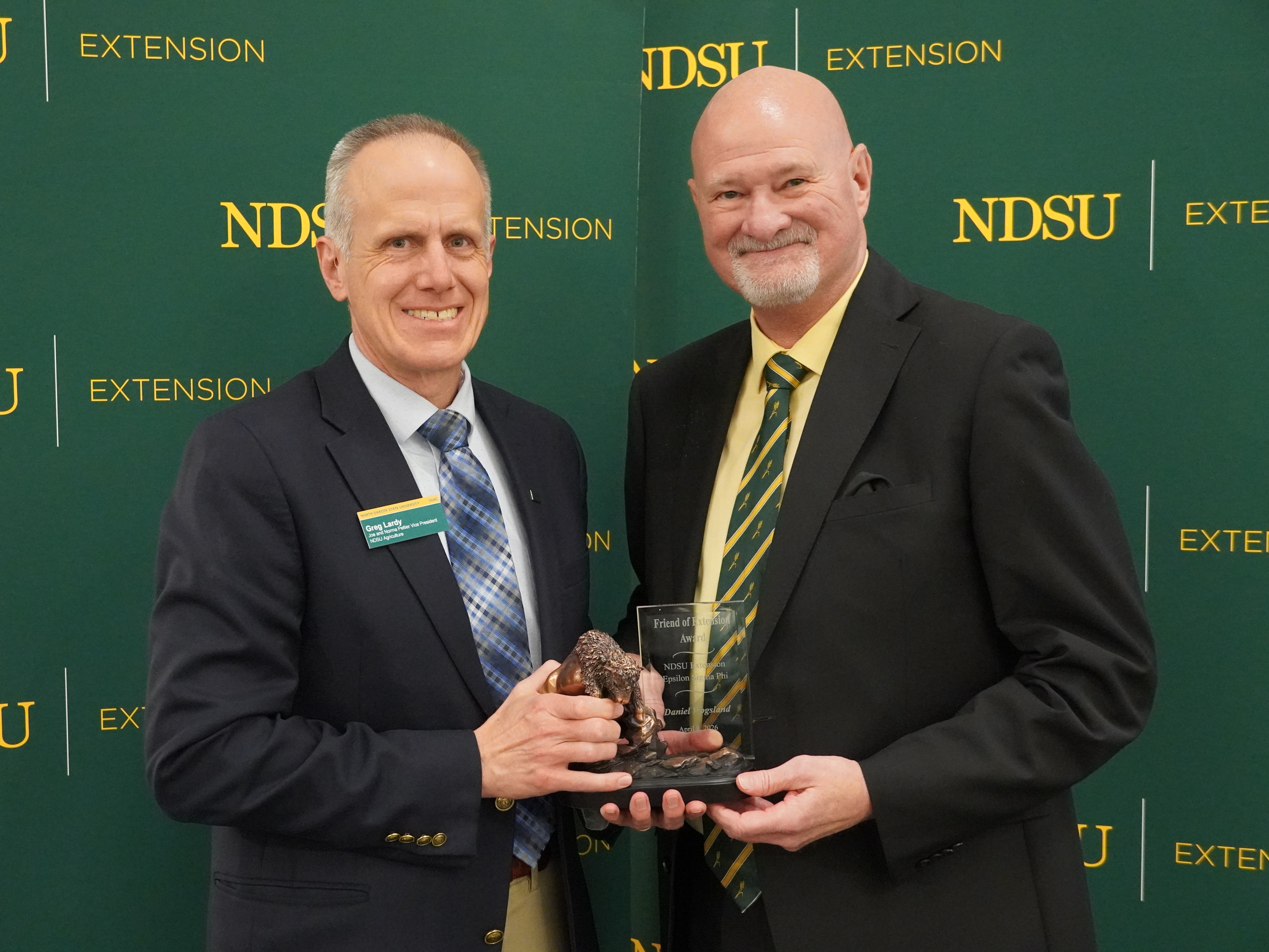 Dan Wogsland (right), former North Dakota Grain Growers Association executive director, is honored with the 2026 Friend of Extension award by Greg Lardy (left), Joe and Norma Peltier Vice President for Agriculture at NDSU. (NDSU photo)