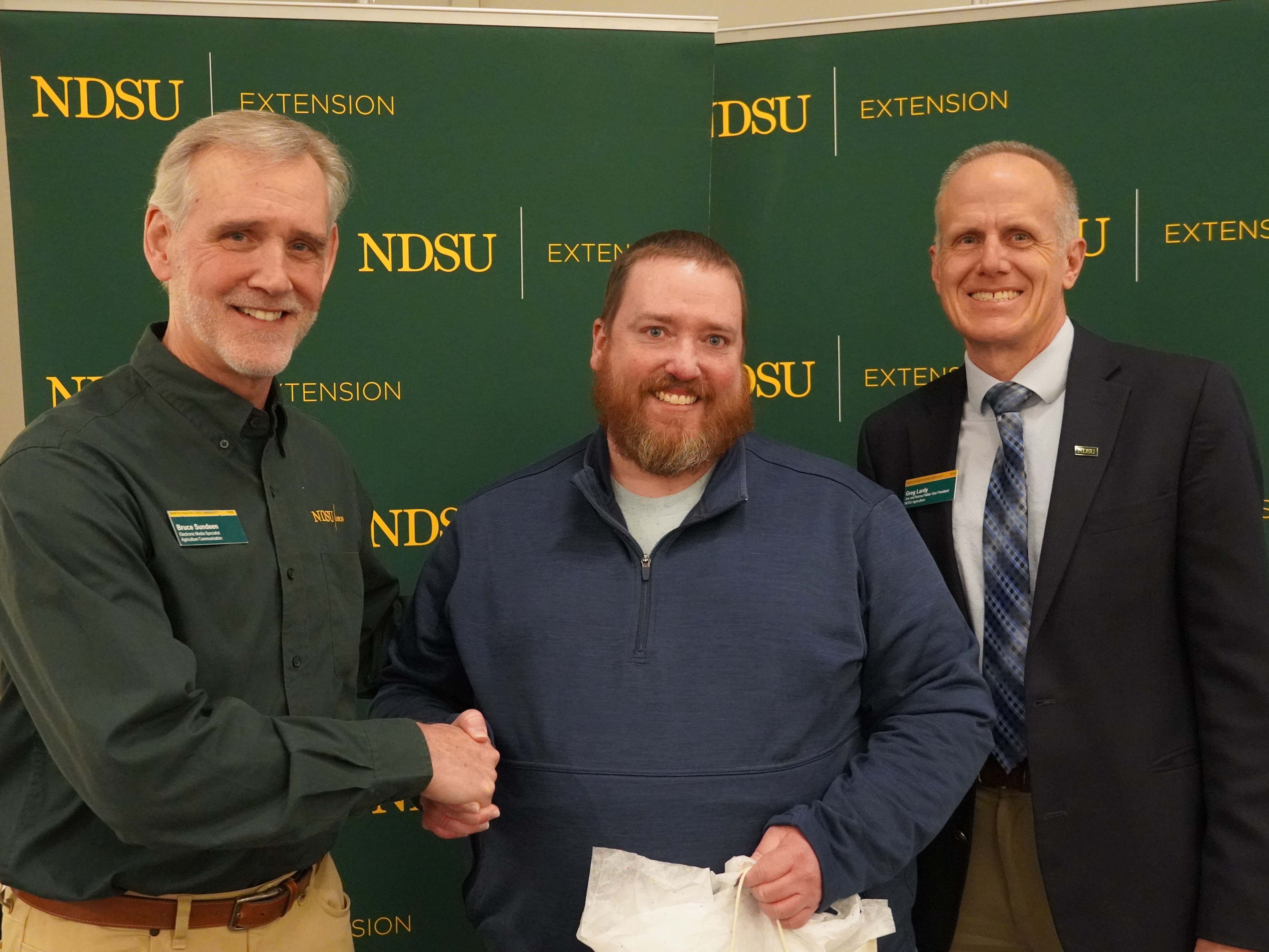 Joe Ikley (center), NDSU Extension weed specialist, is honored with the Communicator of the Year Award by Bruce Sundeen (left), electronic media specialist for NDSU Agriculture Communication, and Greg Lardy (right), Joe and Norma Peltier Vice President for Agriculture at NDSU.