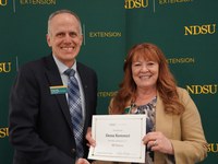 Dena Kemmet (right), NDSU Extension Central District director, is honored for 35 years of service by Greg Lardy (left), Joe and Norma Peltier Vice President for Agriculture at NDSU. (NDSU photo)