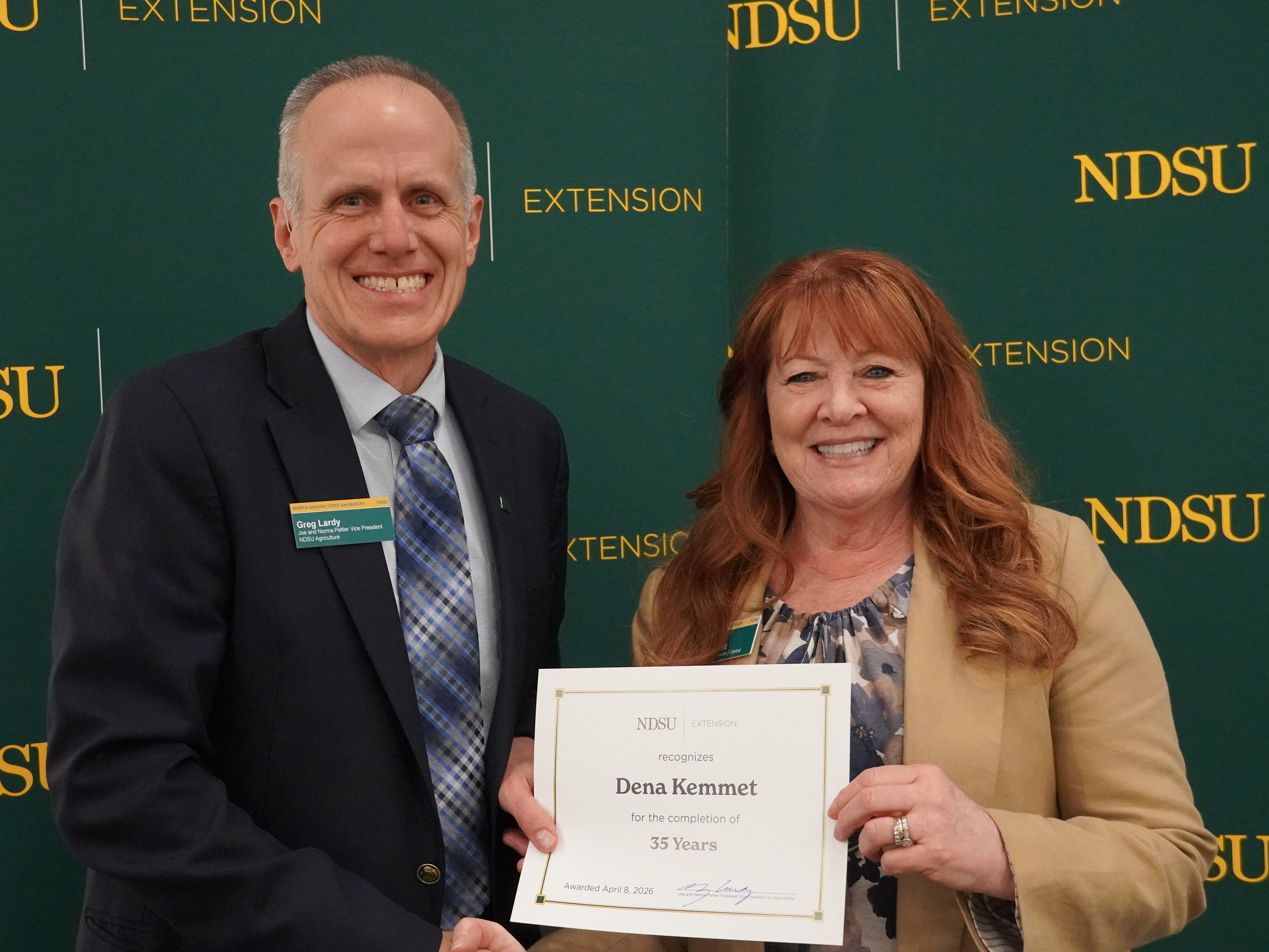 Dena Kemmet (right), NDSU Extension Central District director, is honored for 35 years of service by Greg Lardy (left), Joe and Norma Peltier Vice President for Agriculture at NDSU. (NDSU photo)