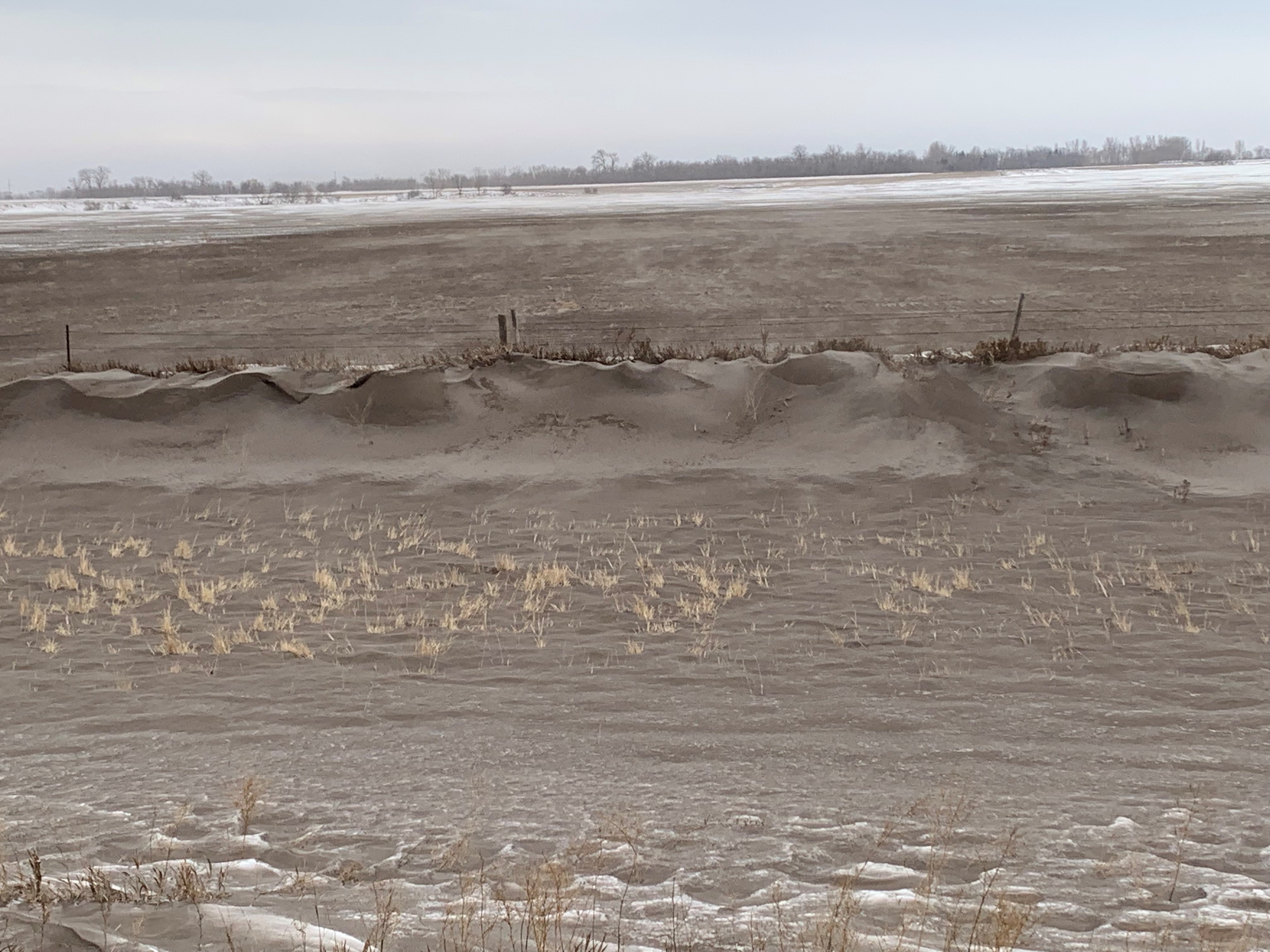 A roadside ditch along Highway 2, about 5 miles west of Grand Forks, North Dakota, full of topsoil from the adjoining field that was tilled in the fall. (NDSU photo)