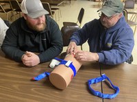 Participants at a Stop the Bleed training practice properly using a tourniquet in the event of blood loss caused by an injury. (NDSU photo)